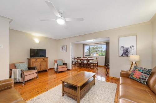 a living room with a couch and a table at 19 Pindari Parade Port Macquarie in Port Macquarie
