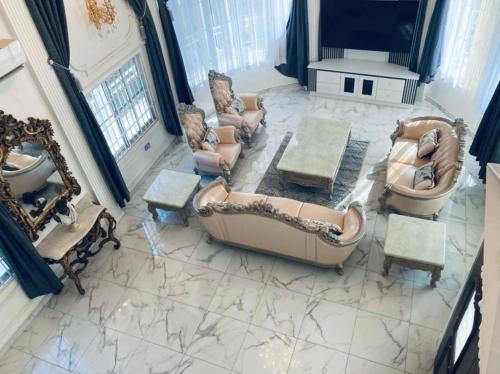 an overhead view of a living room with a couch and chairs at The Peacock Mansion in Kumasi