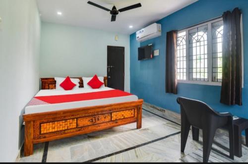 a bedroom with a bed and a chair and a desk at The pearl guest house in Visakhapatnam