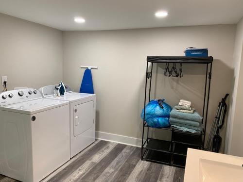 a laundry room with a sink and a washing machine at Newly Renovated Lincolnton Downtown Rail Trail Apartment - Walk to Main St in Lincolnton