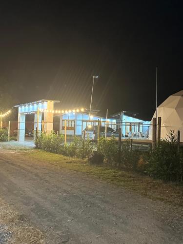 a lit up building at night with a street at Eco Cabañas Montana in Santa Helena