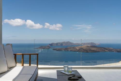 a view of the ocean from a room with a couch and a table at Vedema, a Luxury Collection Resort, Santorini in Megalokhori