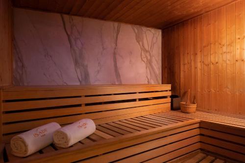 a wooden sauna with two towels on thevisor at Lagos Marriott Hotel Ikeja in Lagos