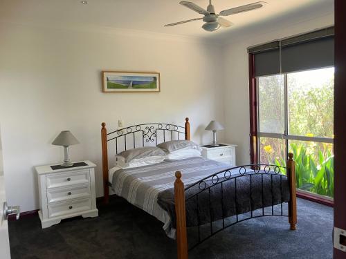 a bedroom with a bed and a window at Eagle Bay Views in Eagle Point