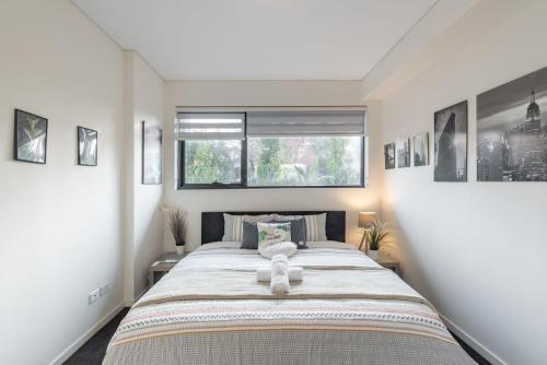 a bedroom with a large bed and a window at King bed Apt Study Homebush Sleeps 3 in Sydney
