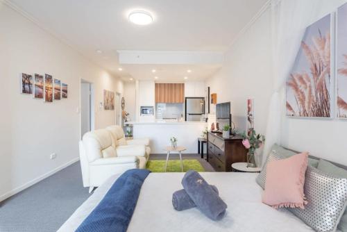 a bedroom with a bed and a living room at 2BR Apt in Hurstville 1Min To Train Station Sleep 8 in Sydney
