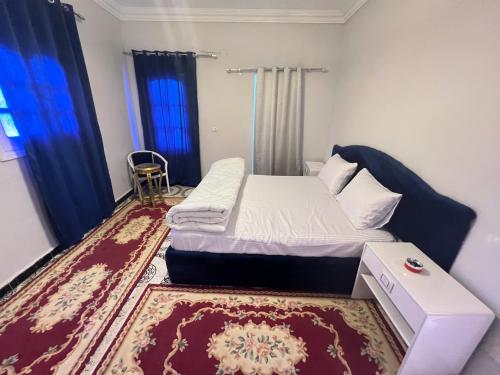 a small bedroom with a bed and a rug at King pyramids view inn in Cairo