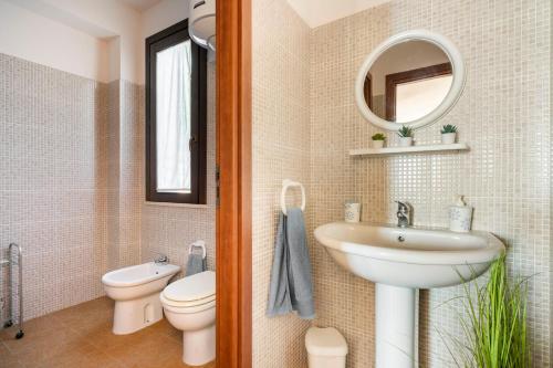 uma casa de banho com um lavatório, um WC e um espelho. em Casa Vacanze Albarìa em Birgi Vecchi
