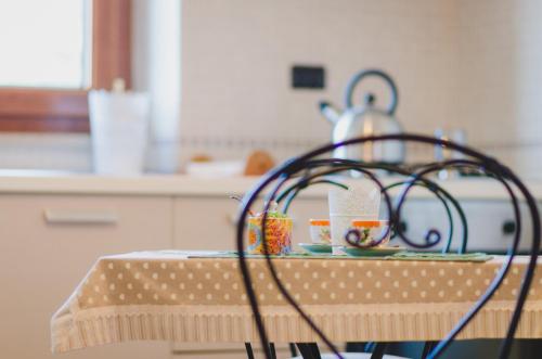 a kitchen with a chair with cups on a table at B&B da Mary in Matrice
