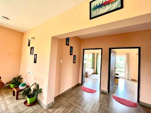 a living room with orange walls and red rugs at Moonlight Chillers By LexStays in Yedapalli