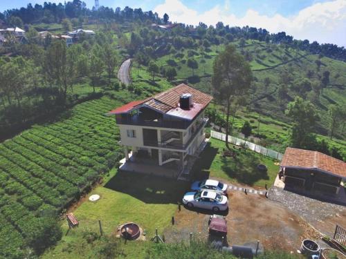 a house with a car parked in front of it at Moonlight Chillers By LexStays in Yedapalli
