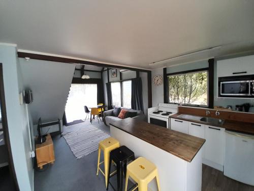 a kitchen and living room of a tiny house at Tokaanu Lodge Motel in Turangi