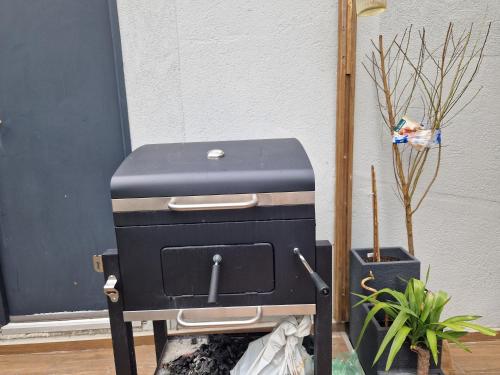 a suitcase sitting on a stand next to a plant at F2 type apartment Near Stade de France in Saint-Denis