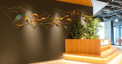 a wall with a bunch of triangles on it at Grids Premium Hotel Kumamoto in Kumamoto