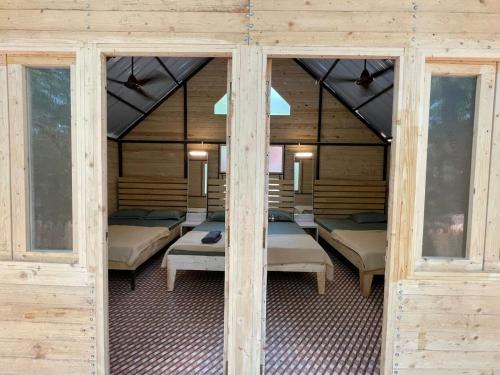 a room with a bunch of beds in it at Nature Glamping in Matheran