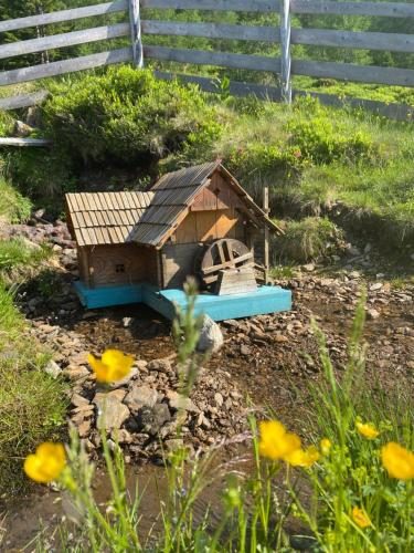 a bird house sitting on the ground in a garden at Almhütte auf der Laußnitz Alm - Auszeit in schöner Bergidylle auf 1836m in Rennweg