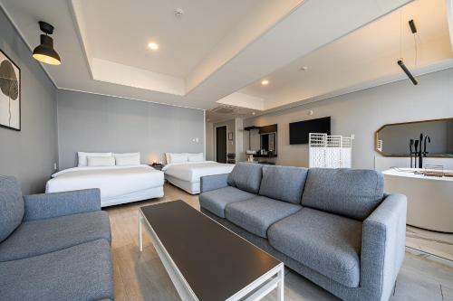 a living room with a couch and a bed at Stay Hostel in Sokcho