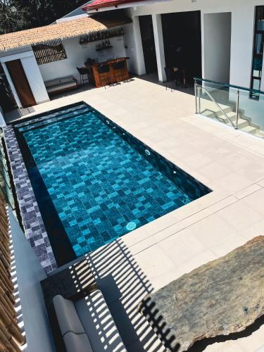 a swimming pool on the side of a house at Go Boutique Inn in Puerto Princesa City