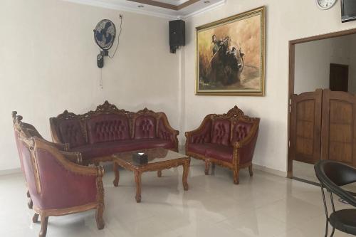 a living room with two chairs and a table at GB 2 Backpacker Borobudur in Sekatonan