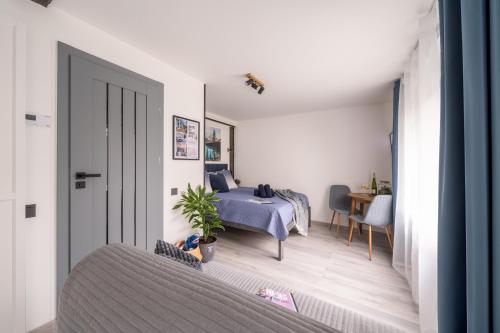 a bedroom with a bed and a table in a room at Green Garden & Parking Apartments in Rīga