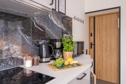 a kitchen counter with a tray of fruit on it at Green Garden & Private Parking Apartments with Playground in Rīga