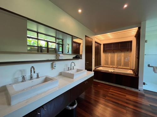 a large bathroom with two sinks and a tub at Amatapura Beachfront Villa 1, SHA Certified in Ao Nam Mao