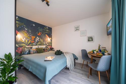 a bedroom with a bed and a table in it at Green Garden & Parking Apartments in Riga