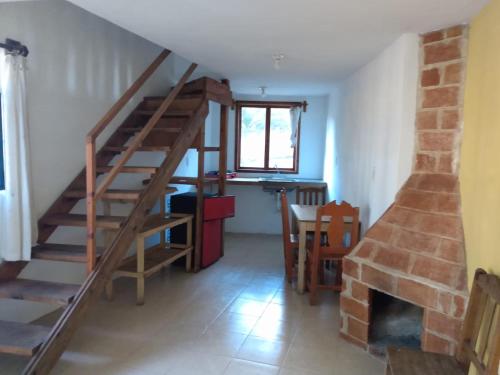 a living room with a staircase and a fireplace at LOS ALAMOS in San Cristóbal de Las Casas