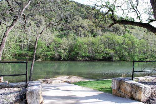 a path next to a body of water at River Road Villas #2 in New Braunfels