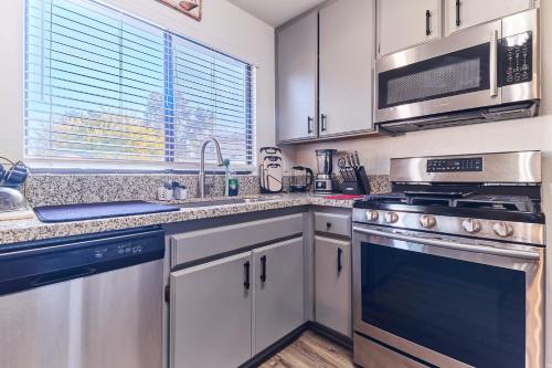 a kitchen with stainless steel appliances and a window at Entire Mountain Oasis Home in Hemet