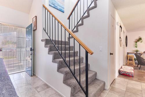 a staircase in a home with white walls and wood floors at Entire Mountain Oasis Home in Hemet