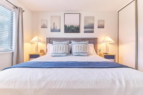 a bedroom with a large bed with two lamps at Entire Mountain Oasis Home in Hemet