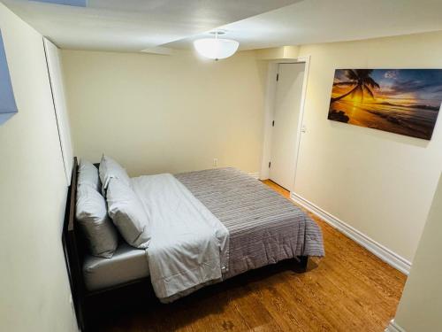 a bedroom with a bed and a painting on the wall at Scotchmere Serenity: Modern 1-Bedroom Brampton Haven in Brampton