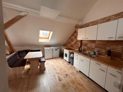 a kitchen with white cabinets and a table in it at private house in Ústí nad Labem
