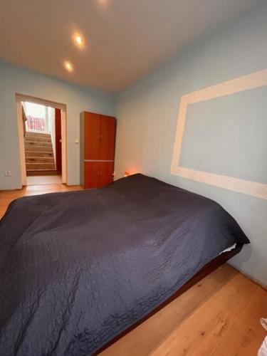 a bedroom with a black bed and a window at private house in Ústí nad Labem