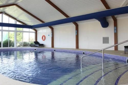 a large swimming pool in a building at The Beach Retreat in Par