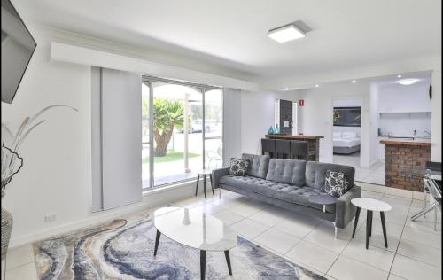 a living room with a couch and a table at Mildura Holiday Villas in Mildura