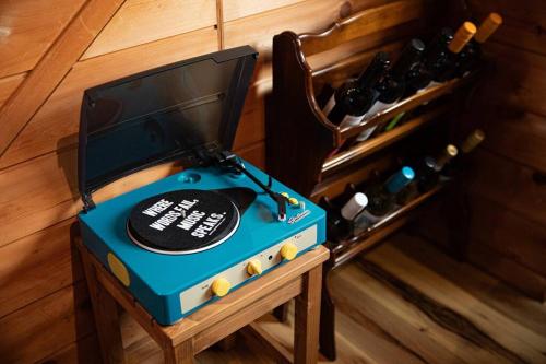 a blue machine sitting on a table with wine bottles at The Archaic / Luxury apartment near Shinjuku in Tokyo