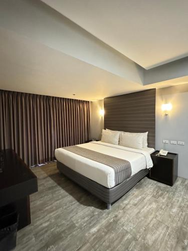 a hotel room with a bed and a television at 1A Express Hotel in Cagayan de Oro