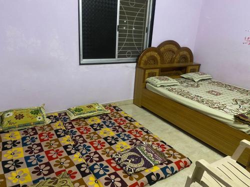 two beds sitting next to each other in a bedroom at Laxmi Kunj in Akalkot