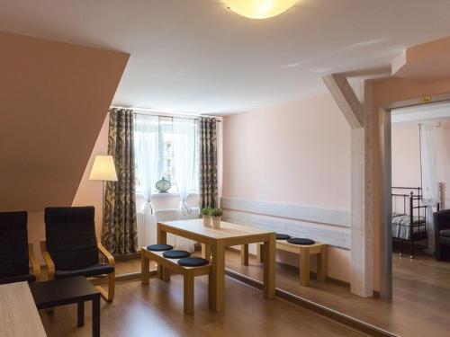 a living room with a table and some chairs at Penzion Na Palubě in Jeseník