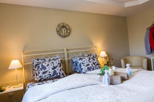 a bedroom with a large bed with blue and white pillows at Penzion Na Palubě in Jeseník