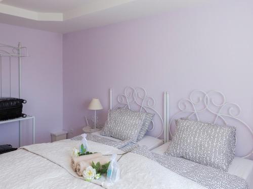 a white bedroom with a white bed with two pillows at Penzion Na Palubě in Jeseník