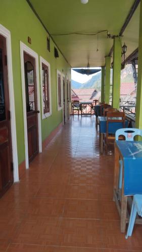 an empty hallway of a house with green walls at Amphai Guest house in Nongkhiaw
