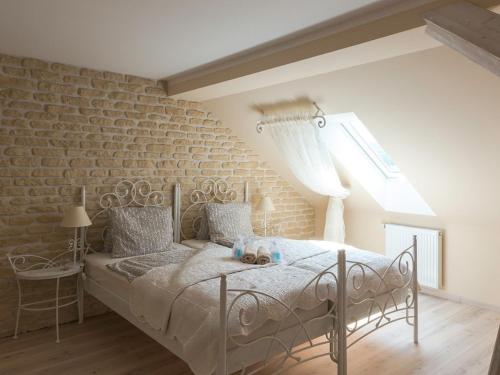 a bedroom with a bed and a brick wall at Penzion Na Palubě in Jeseník