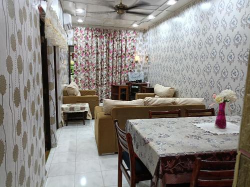 a living room with a couch and a table at Homestay Bemban Batu Gajah in Batu Gajah