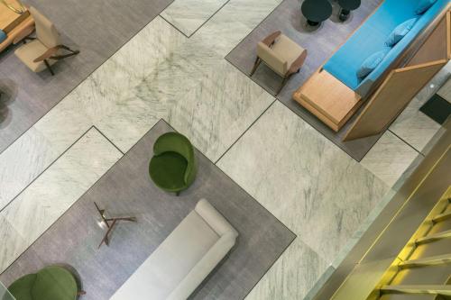 an overhead view of a bathroom with a green chair and tables at Le Meridien Batumi in Batumi