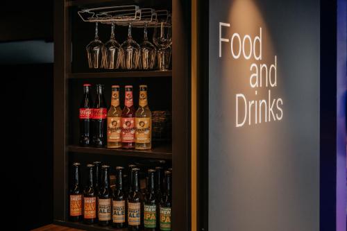 a refrigerator filled with lots of bottles of alcohol at Capsule Hotel - Chapter Lucerne in Luzern