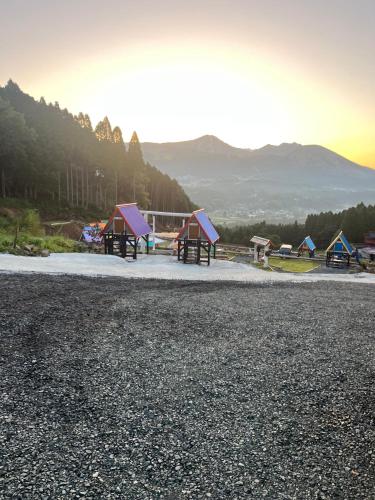 a group of tents on a gravel road at パワースポットキャンプ場 in Shimoda