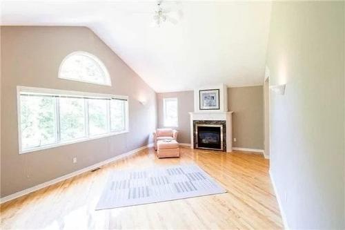 an empty living room with a chair and a fireplace at Beautiful Private Room Near Restaurants Shopping and Transit P1 in Pickering